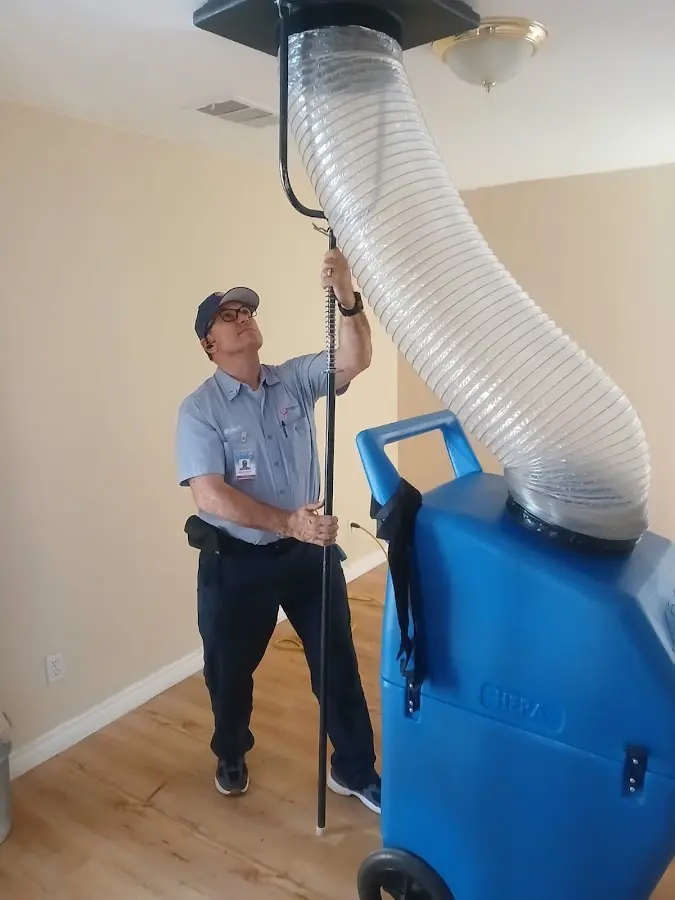 Furnace Tune-Up technician using HEPA equipment in Streamwood